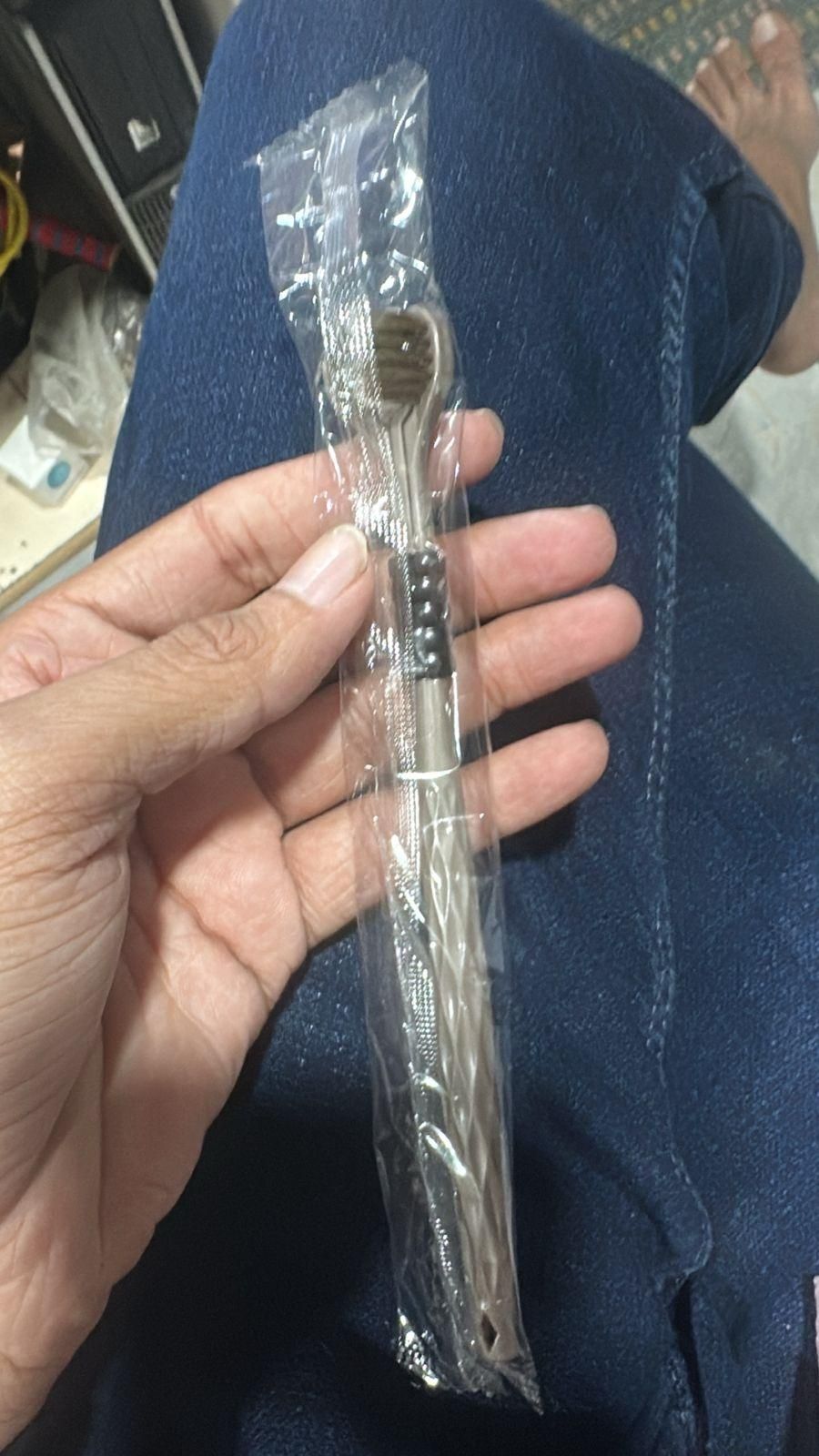 Best toothbrush for braces and sensitive gums in clear packaging held in hand